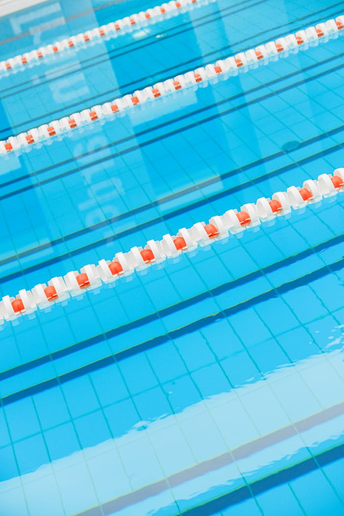 services-01 Indoor swimming pool with clear blue water and lane dividers. Perfect for sports and recreation imagery.